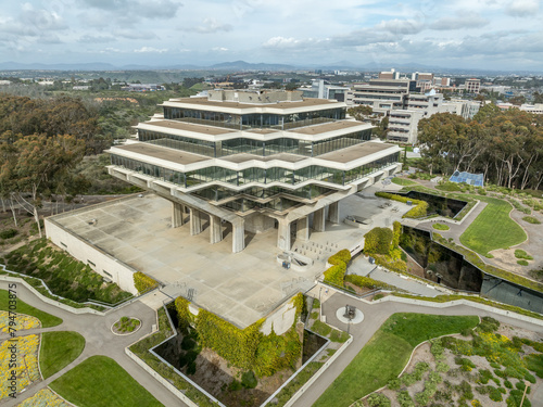 Aerial view of Geysel library at the University of California San Diego, futuristic building, columns holding up upper floor like books, next to the snake path photo