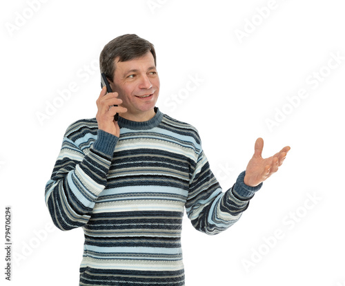 Portrait of fifty year old guy talking on mobile phone, isolated on white background. Man in striped sweater thoughtfully looks a side and gestures with his hand and posing in studio.