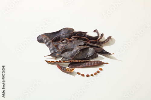 A pile of black locust pods isolated on white background from high angle shot. Vacant space for displaying product made from black locust, copy space