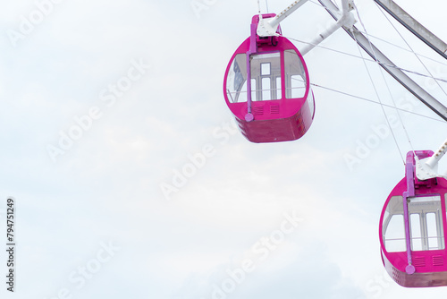 Close up red color Ferris Wheel on amusement park with cloud background