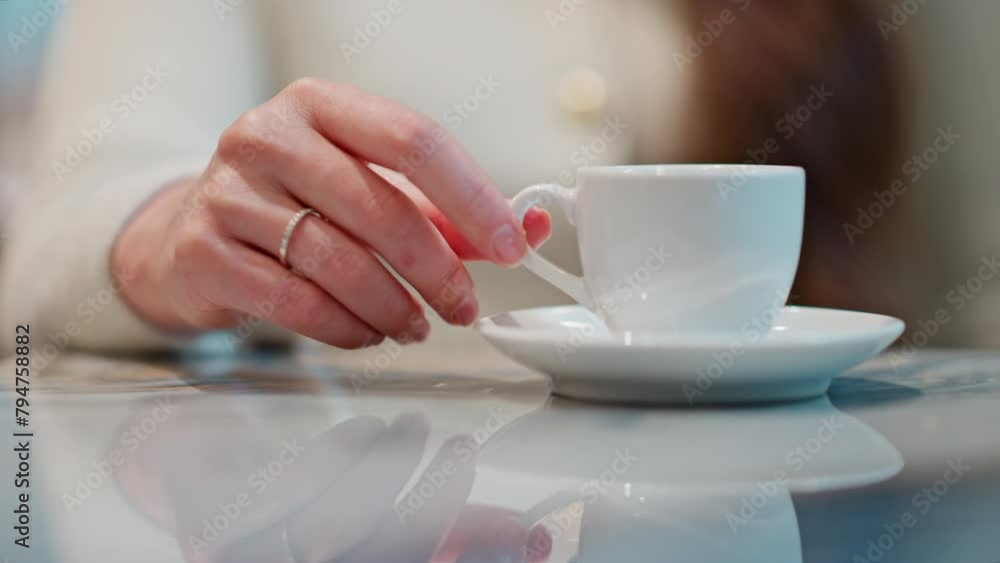 Woman holding a cup of coffee on a table Woman holding a cup of coffee on a table