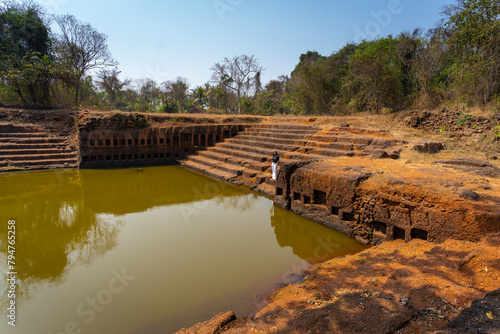 Restored pond with carved niches of 15 th century Sri Saptakoteshwar Temple built by Kadamba Kings in Divar island in Goa, India. The temple was totally destroyed during the Portuguese occupation. photo