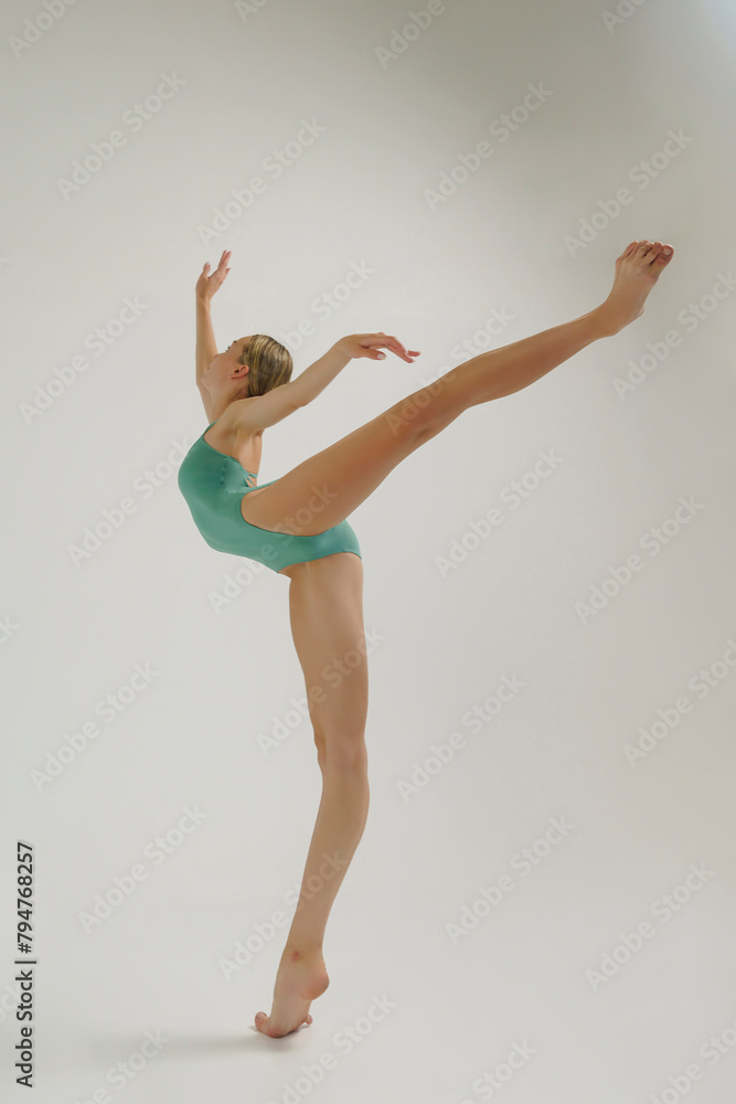 young ballerina in a bodysuit performs an attitude