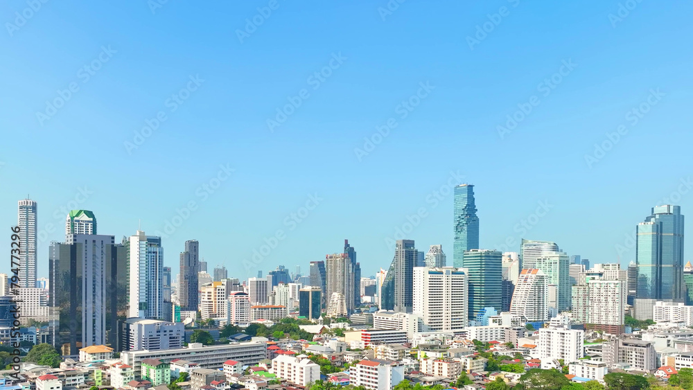 Drone Aerial view, Observing urban landscape, drone navigates through high-rise clusters and towering skyscrapers. Metropolitan concept. Bangkok, Thailand.
