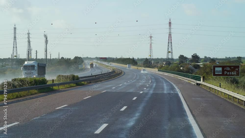 First person view driving on wet highway with power lines First person view driving on wet highway with power lines
