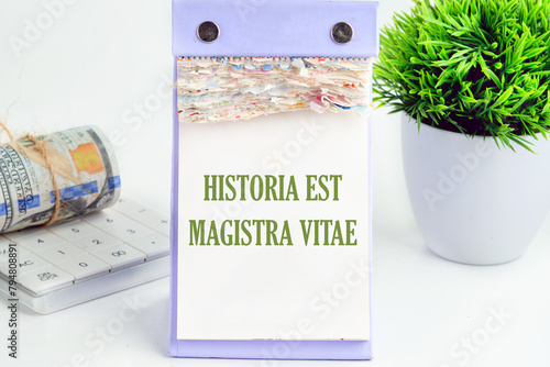 Historia est vitae magistra (History is the tutor of life) Latin phrase It is written on a piece of desktop calendar on a white background photo