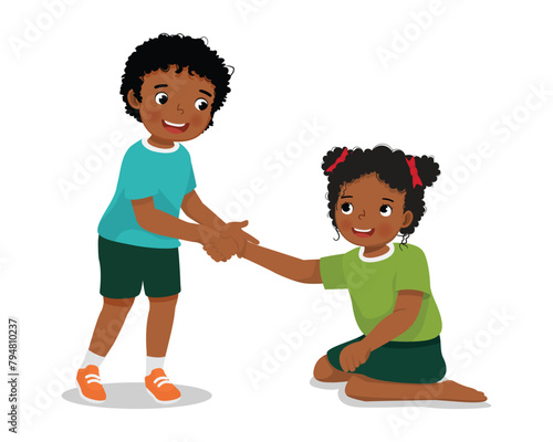 Cute little African boy helping his friend who has fell down to stand up 