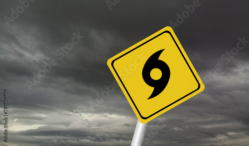 Hurricane Idalia warning sign against a powerful stormy background with copy space. Dirty and angled sign with cyclonic winds add to the drama.hurricane season sign on cloudy background photo