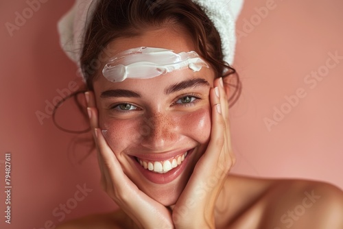 A young woman with radiant skin, holding a skincare product. She's wearing a mask and has a serene expression. photo