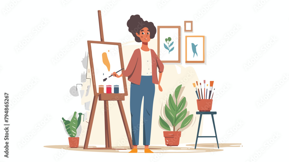 Cheerful young woman painting in her art studio Hand