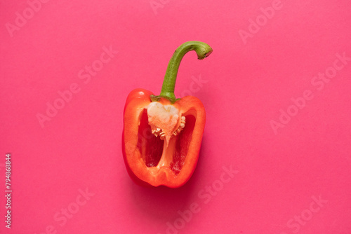 Red bell pepper on a pink background. The concept of healthy eating.