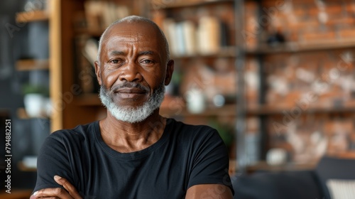A portrait of a senior African American man with a white beard wearing a black shirt