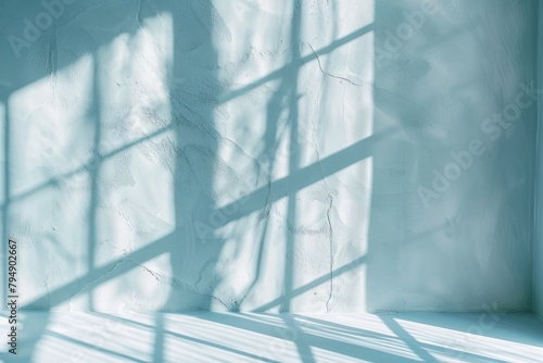 Closeup of a ladders shadow cast on a light blue wall, showing subtle nuances of shadows and gentle illumination
