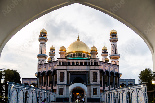 view of the gold domes of Jame' Asr Hassanil Bolkiah Mosque through an archway in Brunei Darussalam on Borneo in Southeast Asia photo