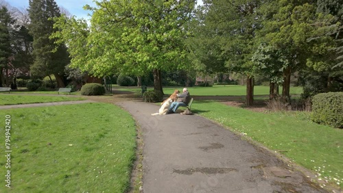 STOKE-ON-TRENT, STAFFORDSHIRE, ENGLAND - APRIL 18 2024: Elderly man with dogs at the park. photo