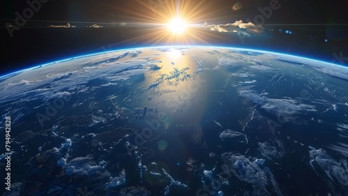 Glowing sunset on Earth's curved horizon in space - The sun sets casting a golden glow on the curvature of Earth against the dark expanse of space, highlighting continents and oceans