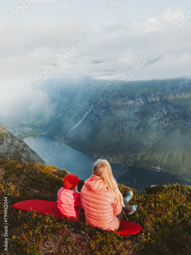 Family camping mother and daughter relaxing in mountains travel vacations picnic outdoor woman with child hiking together active lifestyle adventure trip parent and kid enjoying fjord view in Norway