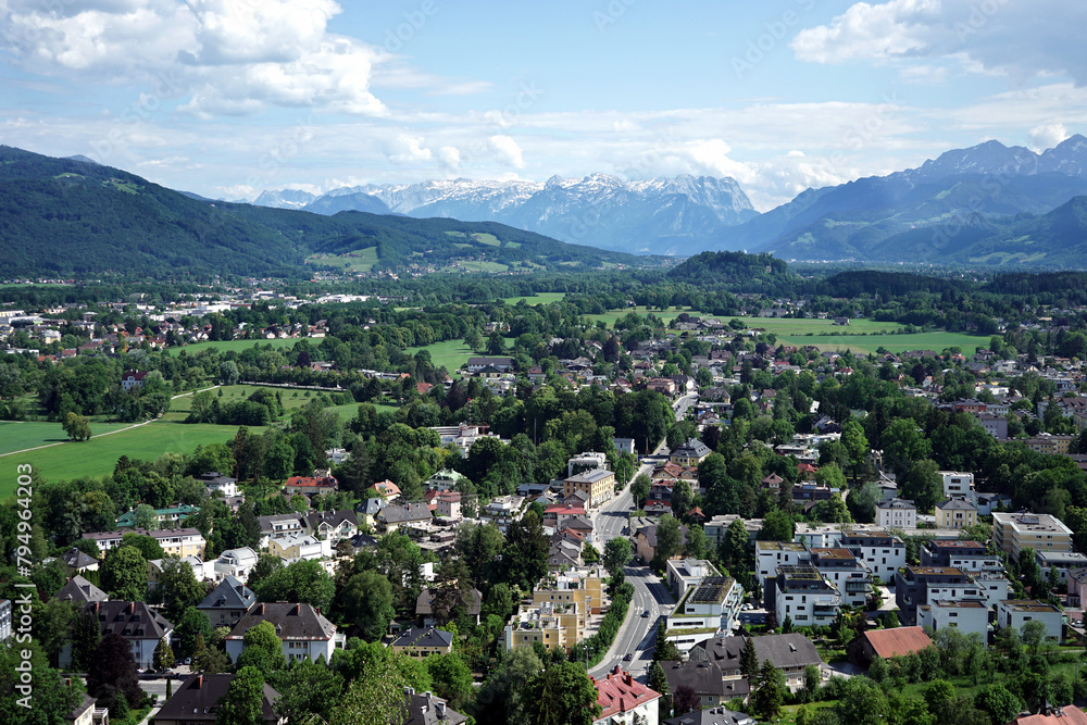 View of Salzburg with snow-capped mountains in the background.