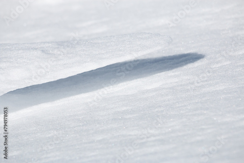 Shadow and close up of thin ledge of snow