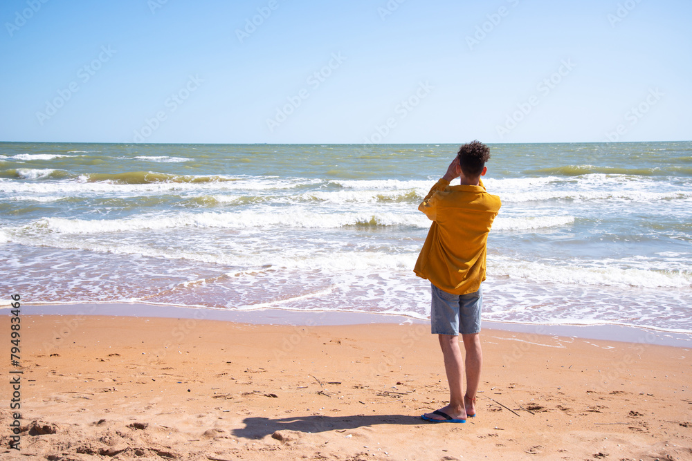 A young attractive man is photographed by the sea. A young attractive man is photographed by the sea.