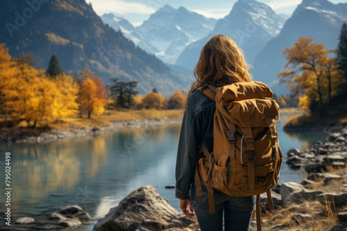 A woman travels in the mountains with a backpack.