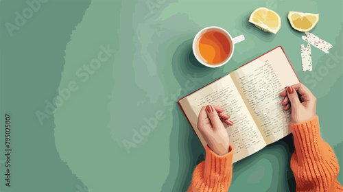 Female hands with book cute bookmarks and cup of tea