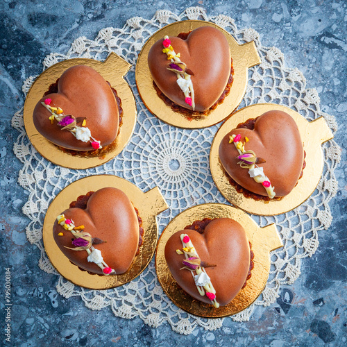 Heart Shaped Chocolate mousse on biscuits layer, white cream lines and dried flowers photo
