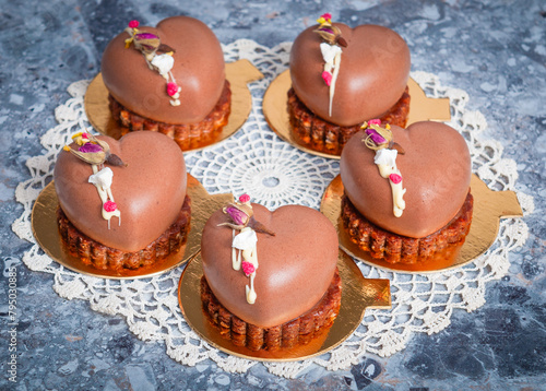 Heart Shaped Chocolate mousse on biscuits layer, white cream lines and dried flowers