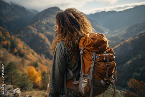 Woman travels in the mountains with a backpack.