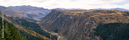 Panoramic scenery of New Zealand's natural landscape with mountains and Queenstown Hill, and Gorge Road winding between the valleys in the distance. photo