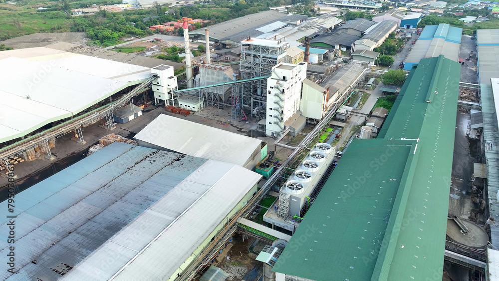 Hidden from the world below, an aerial drone unveils the enigmatic dance of machines outside a paper and packaging factory, where secrets are woven into every product. Aerial view drone.
