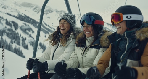 Group of women in ski wear laughing together on a chairlift with a serene snow-covered mountain landscape photo