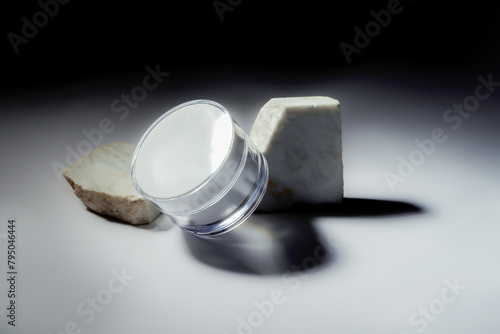 still life of cosmetic cream with marble lights and reflections