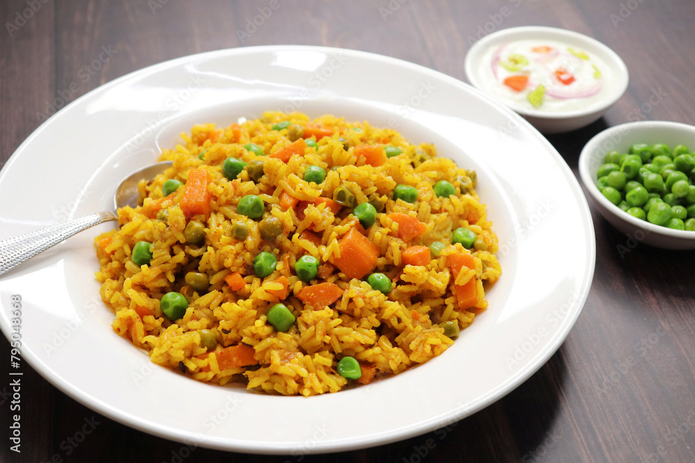 Carrots and Peas Pilaf or Gajar Matar Pulao. It is a one pot rice dish made with Basmati Rice and Vegetables, seasoned with spices, Served with yogurt raita or curd. Healthy weight loss meal. copy