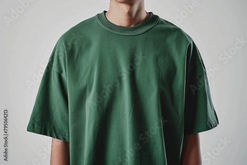 Man wearing a plain green oversized t-shirt photo