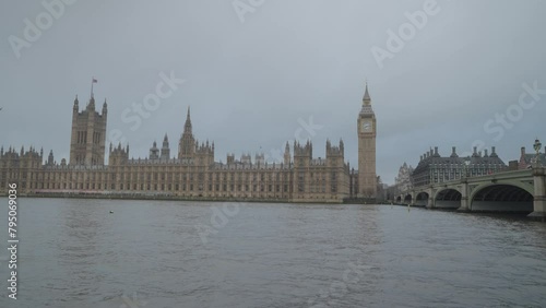 The Thames River in London with Westminster Bridge, Big Ben and the Houses of Parliament and and iconic AEC Routemaster red double-decker buses in London, United Kingdom photo