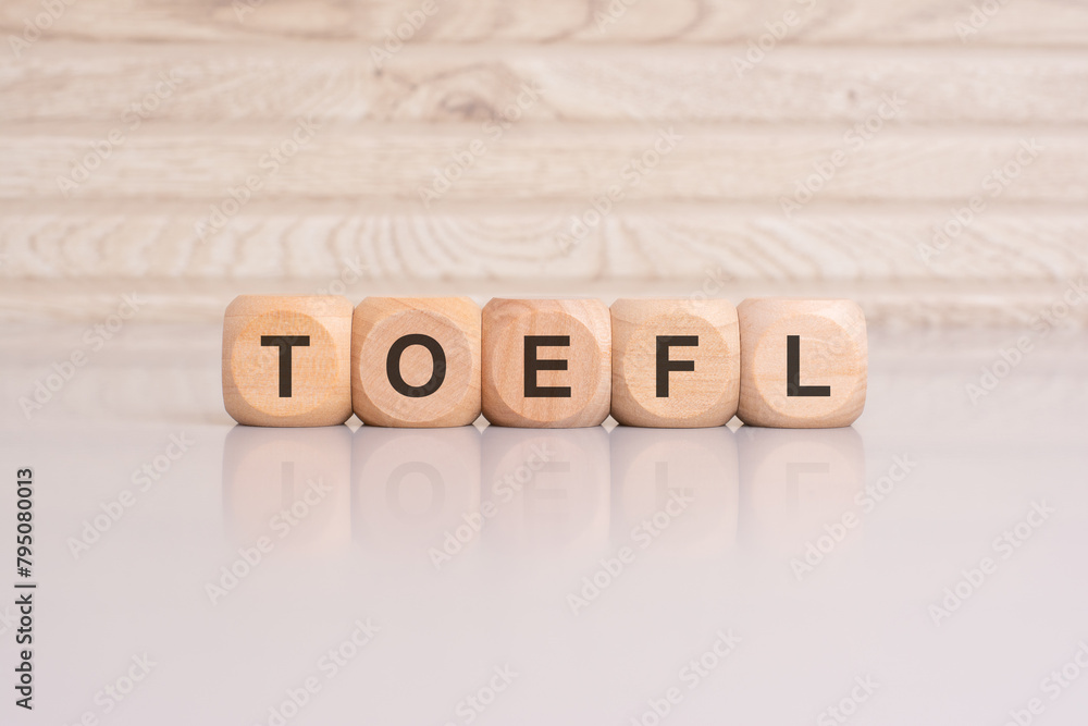 wooden cubes with letters form the expression TOEFL. education concept wooden cubes with letters form the expression TOEFL. education concept