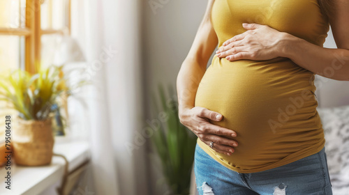 Pregnant woman in contemplation, gently holding her belly by a sunny window, symbolizing expectancy