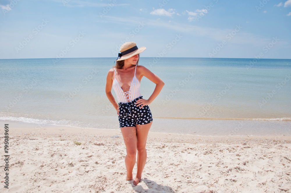 Suntan at summer beach. Beach vacation of retro girl. Sea travel resort. Woman on summer vacation at beach. Summer vacation of woman in swimsuit and straw hat. Retro woman at sea beach. Sunbathe Suntan at summer beach. Beach vacation of retro girl. Sea travel resort. Woman on summer vacation at beach. Summer vacation of woman in swimsuit and straw hat. Retro woman at sea beach. Sunbathe