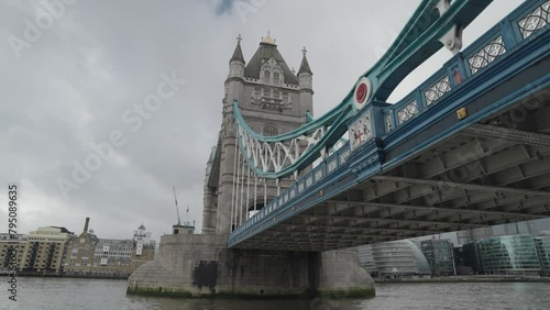 London, United Kingdom - People crossing the Tower Bridge bascule and suspension bridge over River Thames photo