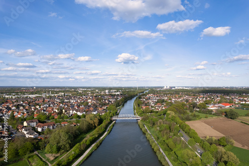 River flowing through a green landscape with houses and trees seen from above Mittellandkanal Hanover © TravelLensPro
