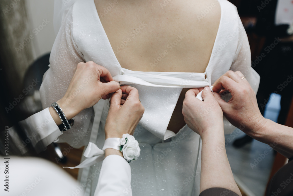 Fototapeta premium Caucasian bride holding dress