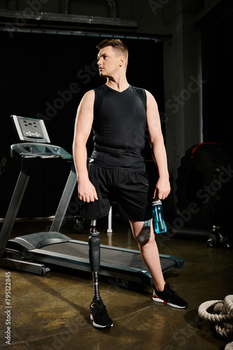A disabled man with a prosthetic leg stands on a treadmill in a gym, determined and focused on his workout routine.