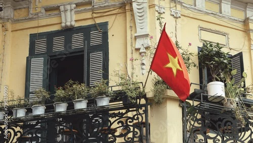 Hanoi, Vietnam - August 23, 2023: Vietnamese flag in a balcony at the Old Quarter