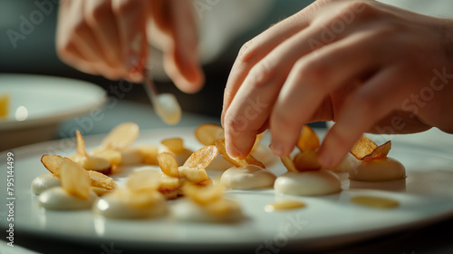 Close-up of the chef's hands plating a meticulously composed appetizer, with each element arranged thoughtfully to create an enticing visual and gastronomic experience. photo