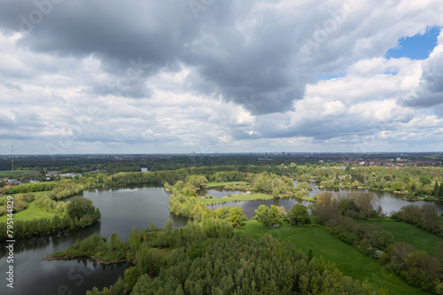 Cloudy day, trees encircling lake, natural landscape view from above Hanover Germany