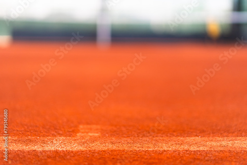 base line of clay tennis court before line brushing process with blurred court as background © angyim