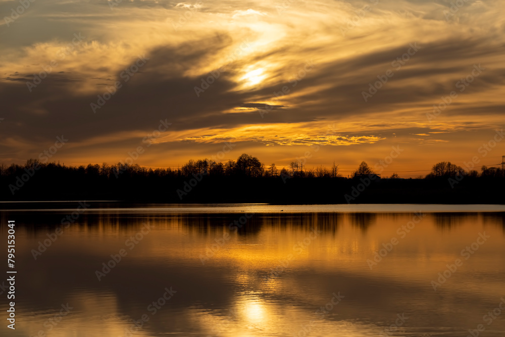 The sky and the lake are red-tinged during sunset The sky and the lake are red-tinged during sunset
