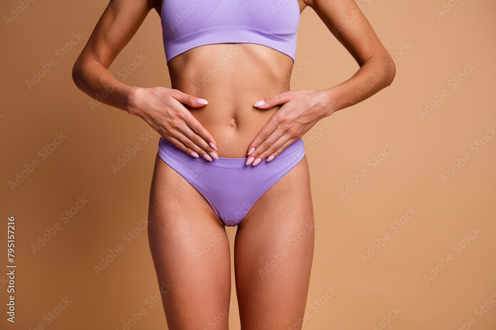 Obraz premium No filter cropped portrait of stunning model girl hands touch belly isolated on beige color background