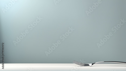 A fork is on a white table. The fork is bent and has a few missing prongs photo
